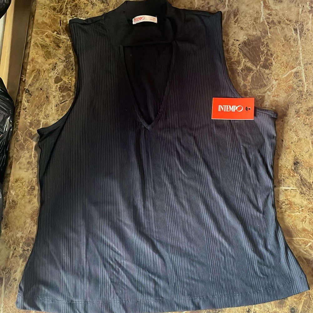 Sleeveless shirt perfect for a casual top to any skirt or pant.